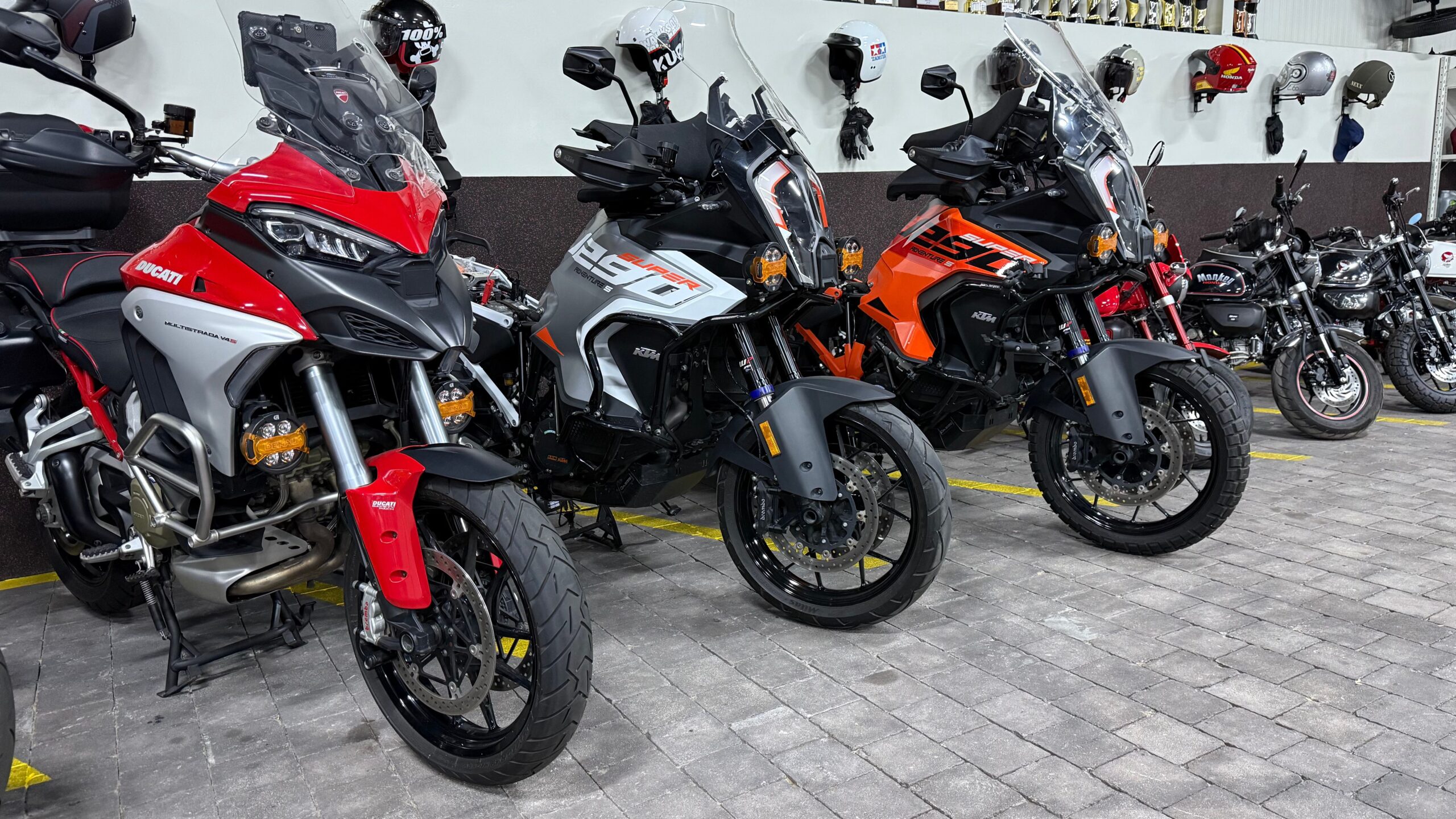 Premium motorcycle storage at Motocare, including Ducati, KTM, and Monkey bikes securely parked in a clean and organized facility.