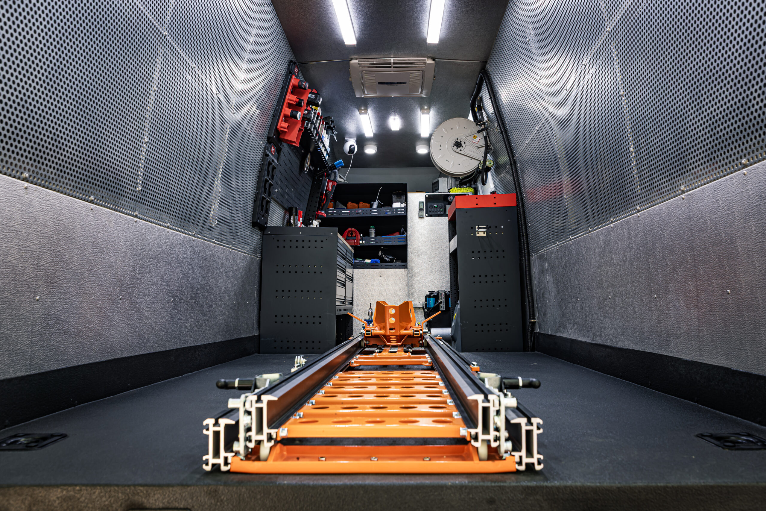 Interior of Motocare’s mobile van with advanced tools, equipment, and secure rail system for Monkey Bike transport and roadside service in the UAE